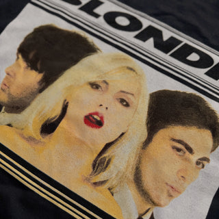 Product with a graphic of three people and the word 'BLOND' on a black background
