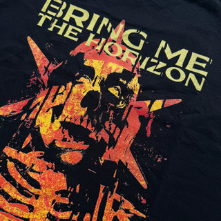 Black t-shirt with a skull design and 'Bring Me the Horizon' text on a dark background