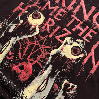 Black t-shirt with graphic design and text on a dark background