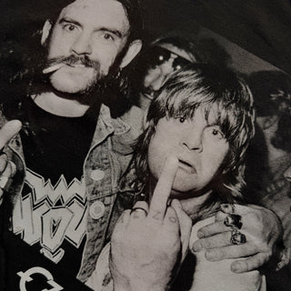 Black and white photo of a group of people with one person making a middle finger gesture.